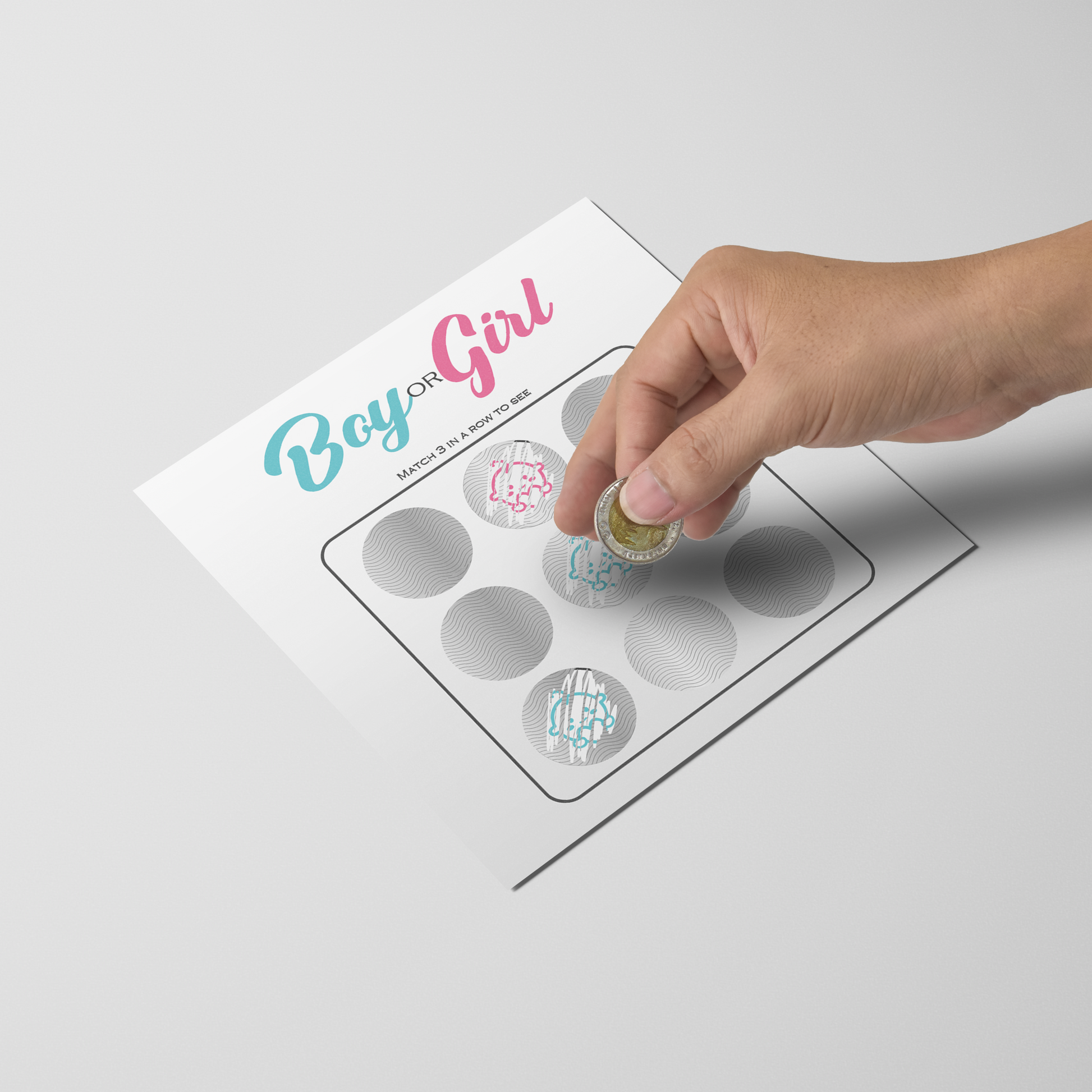 Gender Reveal Scratchie 10 Pack featuring a white card with 'Boy or Girl' text in blue and pink. Hand shown scratching off one of six circular panels with a decorative pattern visible underneath. Perfect for gender reveal parties and announcements.