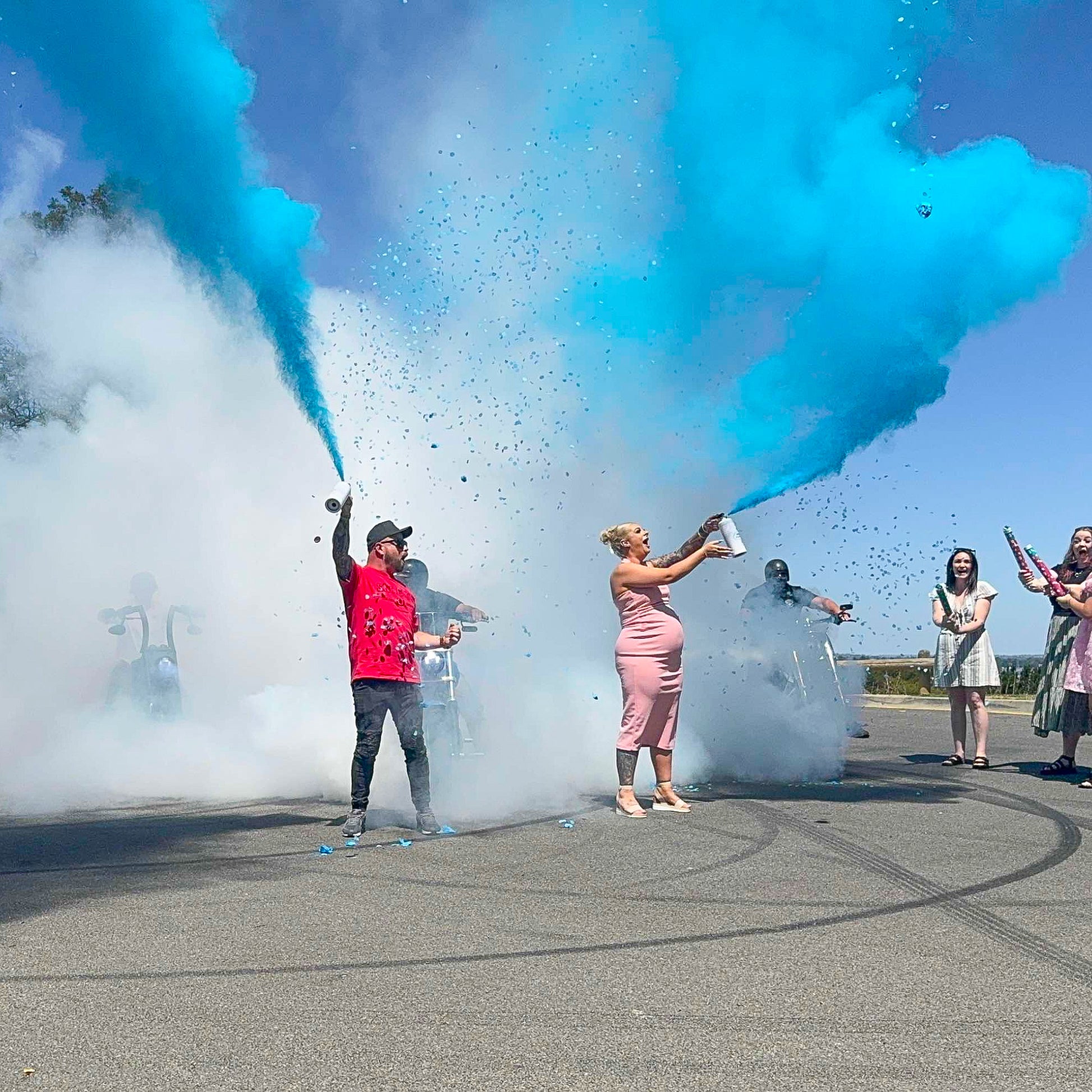 Gender Reveal Double MEGA Powder Blasters creating spectacular blue and white smoke clouds during outdoor celebration demonstration