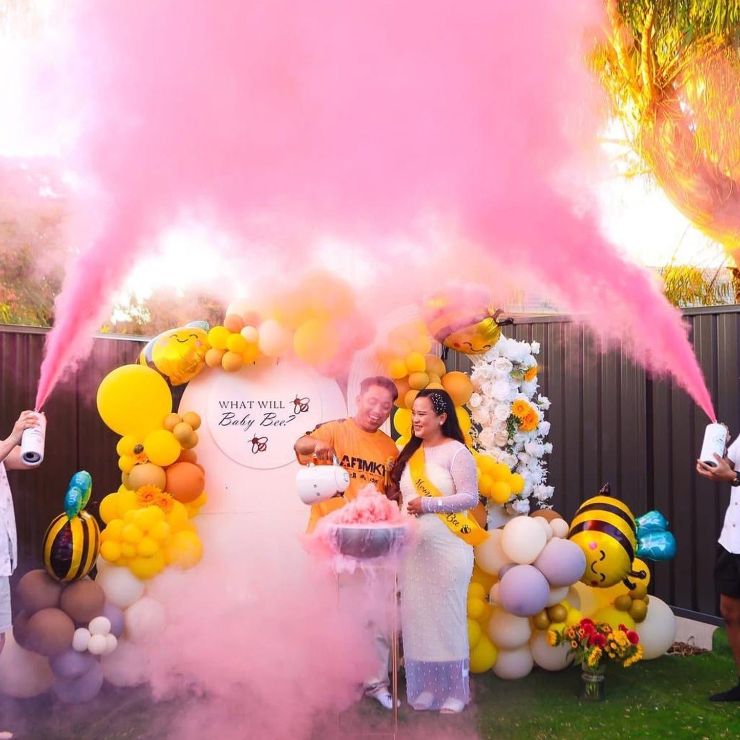 Gender Reveal Extinguisher MEGA Powder Blaster creating dramatic pink smoke clouds at outdoor party with balloon decorations