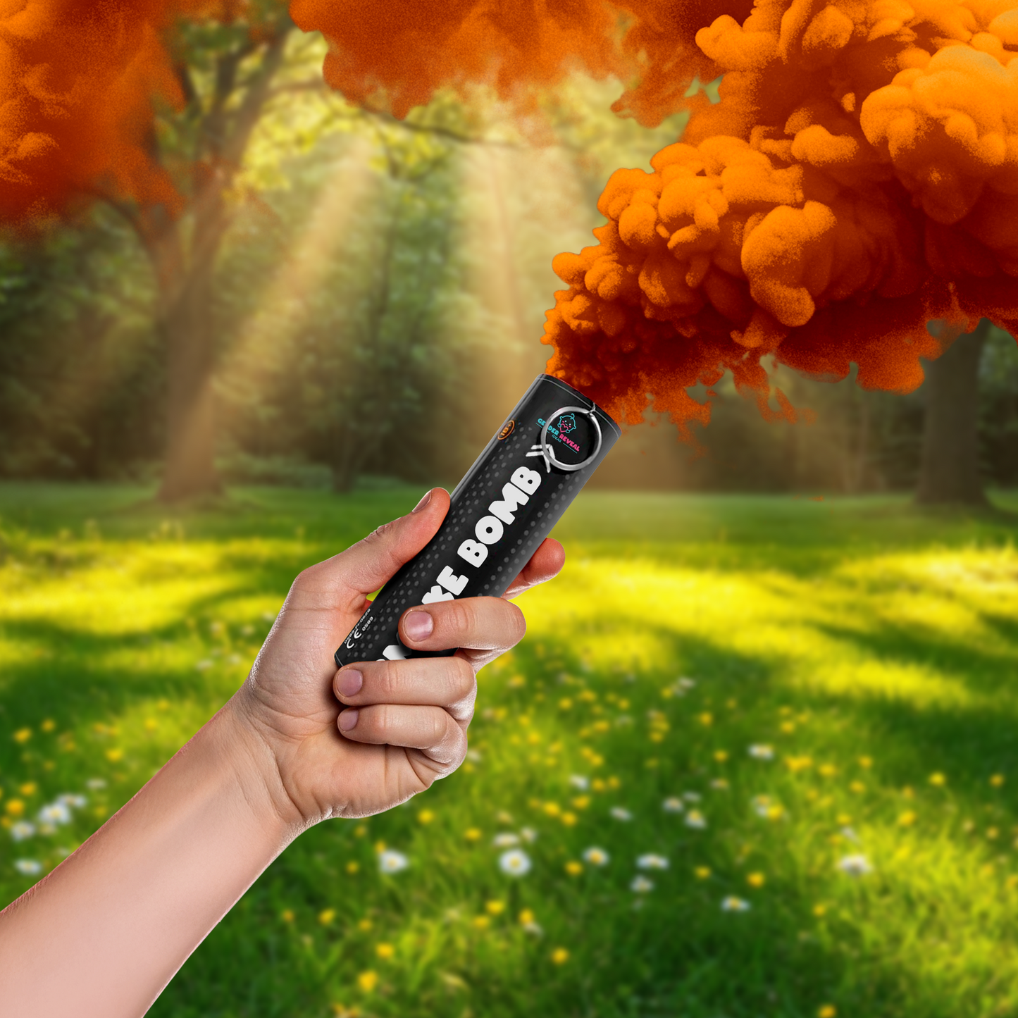 Hand holding Gender Reveal Smoke Bombs emitting orange smoke in a sunlit green outdoor setting.