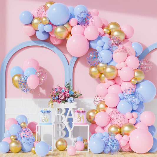 148 Piece Universal Gender Reveal Baby Shower Luxury Balloon Kit displayed as an elegant arch garland with pink, blue, and gold balloons, decorative boxes spelling BABY, and floral arrangements against a pink wall, creating a stunning party backdrop