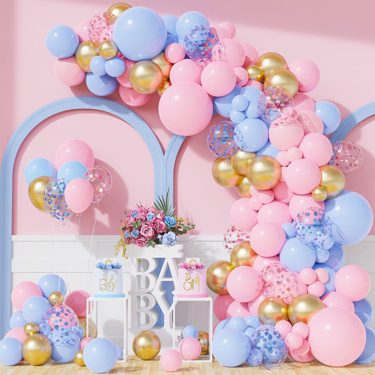 Mega Reveal Gender Party Bundle featuring an elegant balloon arch garland in pink, blue, and gold, decoratively arranged with confetti-filled balloons over white display blocks spelling 'BABY', complemented by floral arrangements and curved architectural elements against a pink backdrop
