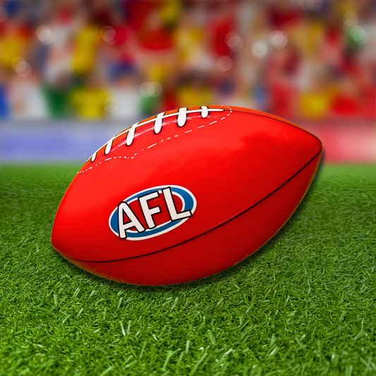 Sports Gender Reveal AFL Ball - Red Australian Rules football with AFL logo on synthetic grass with colorful bokeh background, perfect for gender reveal celebrations