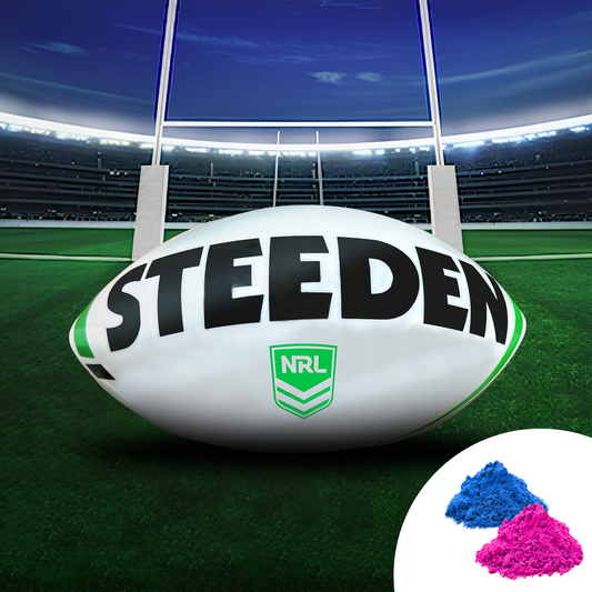 Sports Gender Reveal NRL Rugby Ball displayed on a rugby field with goal posts, featuring a Steeden branded ball. Pink and blue powder samples shown in corner. Stadium lights illuminate the professional sports setting with vibrant green turf.