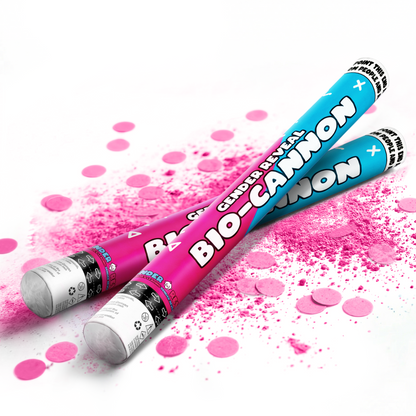 Two gender reveal bio-cannons in blue and pink with pink powder and confetti scattered on white background
