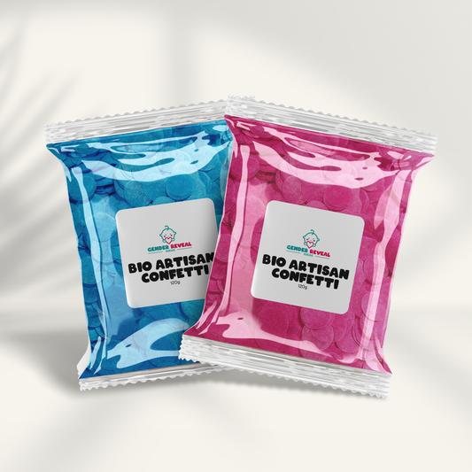 120g BIO Gender Reveal Confetti - Artisan shown in two metallic pouches - one blue and one pink - displaying biodegradable confetti packets with white labels on a light background with subtle shadows, perfect for eco-friendly gender reveal celebrations.