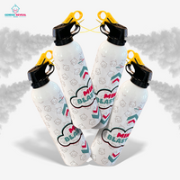 Four white mini powder extinguishers with yellow triggers releasing gray powder for gender reveal celebrations