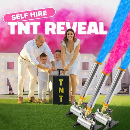 Family using a TNT box with blue and pink powder cannons releasing colored smoke for a gender reveal celebration