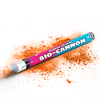 Large gender reveal bio-cannon laying on white surface releasing orange powder for celebration events